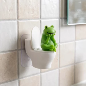 Grenouille verte assise en pose pensive sur une petite cuvette blanche