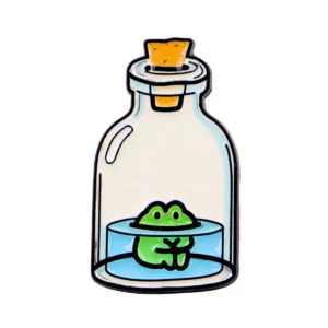 Broche illustrée représentant une grenouille verte dans une fiole